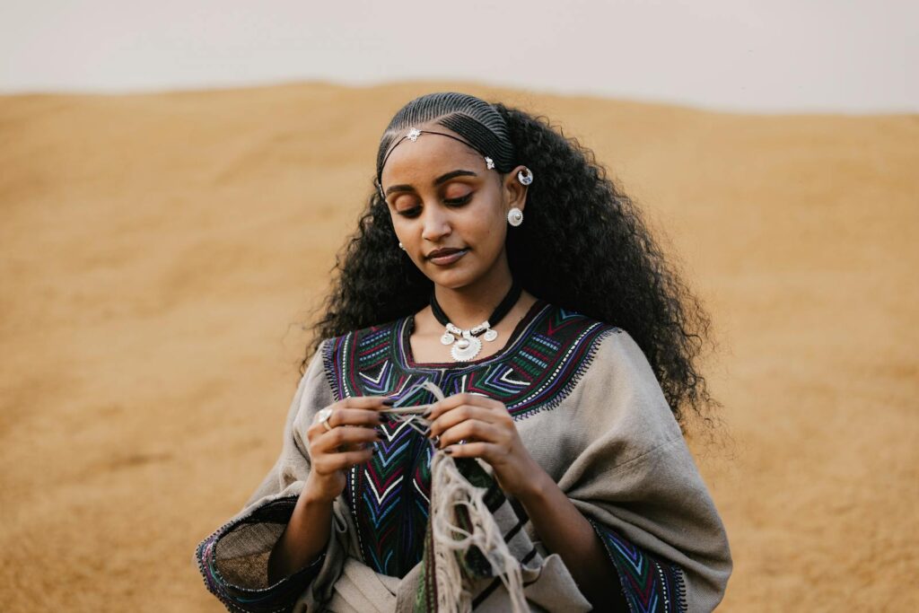 Ethiopian woman in traditional attire engaged in cultural activity, Addis Ababa.