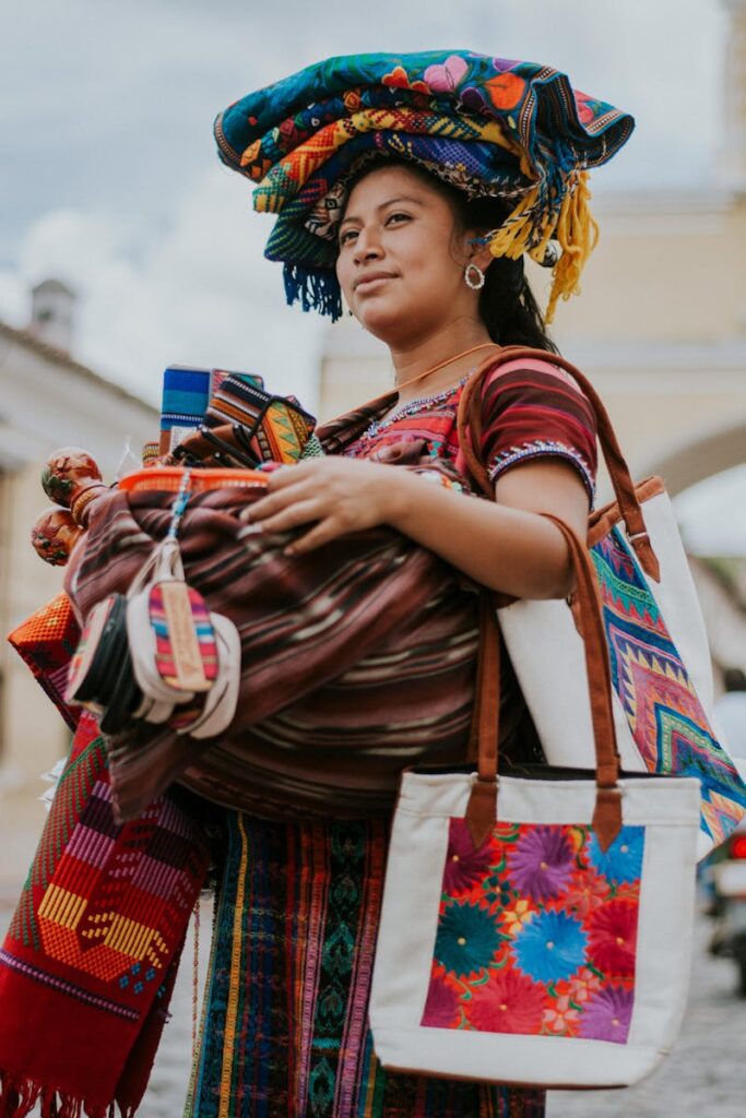 Local street vendor selling colorful textiles in Antigua Guatemala.